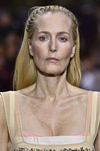 Gillian Anderson walks the Miu Miu runway in a stretchy comb headband.